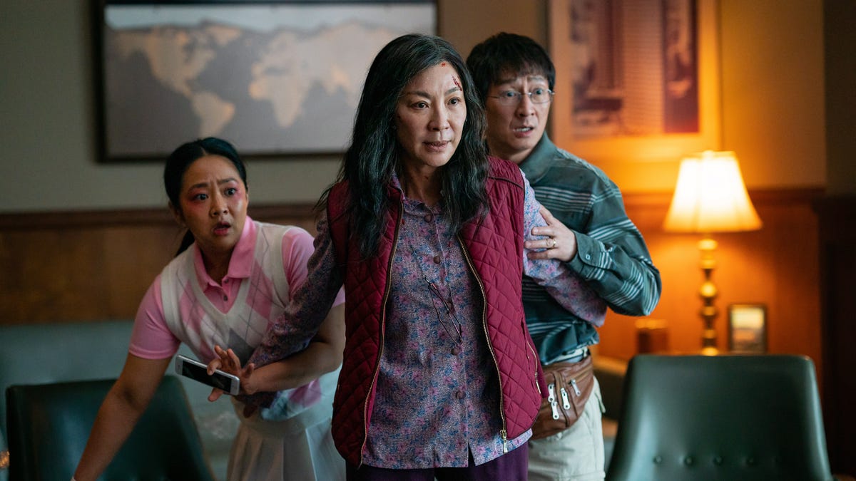 Evelyn (Michelle Yeoh, left), her daughter Joy (Stephanie Hsu) and husband Waymond (Ke Huy Quan) get embroiled in a multiverse-spanning adventure in "Everything Everywhere All at Once."