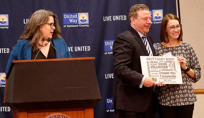 United Way of Ashland County executive director Stacy Schiemann talks about volunteer of the year Brittaney Reep as she poses for a photo with Dan Lawson at the annual meeting Tuesday, April 5, 2022 at John C. Myers Convocation Center. TOM E. PUSKAR/TIMES-GAZETTE.COM
