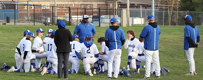 Cambridge head baseball coach Jamaal Lowery, center, talks with his Bobcats following Monday's 7-2 victory over Bellaire in the home opener at Don Coss Stadium. The Bobcats improved to a perfect 3-0 record with the win.