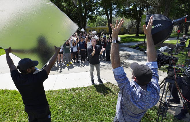 Alex Boylan and a group of students react when prompted during the taping of "The College Tour" on the Jacksonville University campus on Monday, April 4. Boylan, who kicked off his career by winning the "Amazing Race" when he was 23 years old, is a JU alumnus.