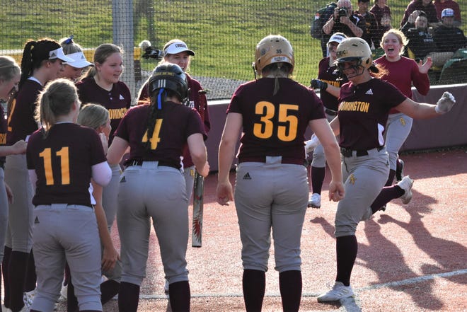 Natalie Burns is greeted at the plate by her teammates after slamming a home run over the fence in left center field against Eastern Greene.