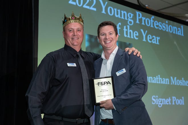 Jonathan Mosher, right, of Signet Pool in Sarasota, was awarded Young Professional of the Year by the Florida Swimming Pool Association. At left is FSPA Board President Mickey Sigmon.
