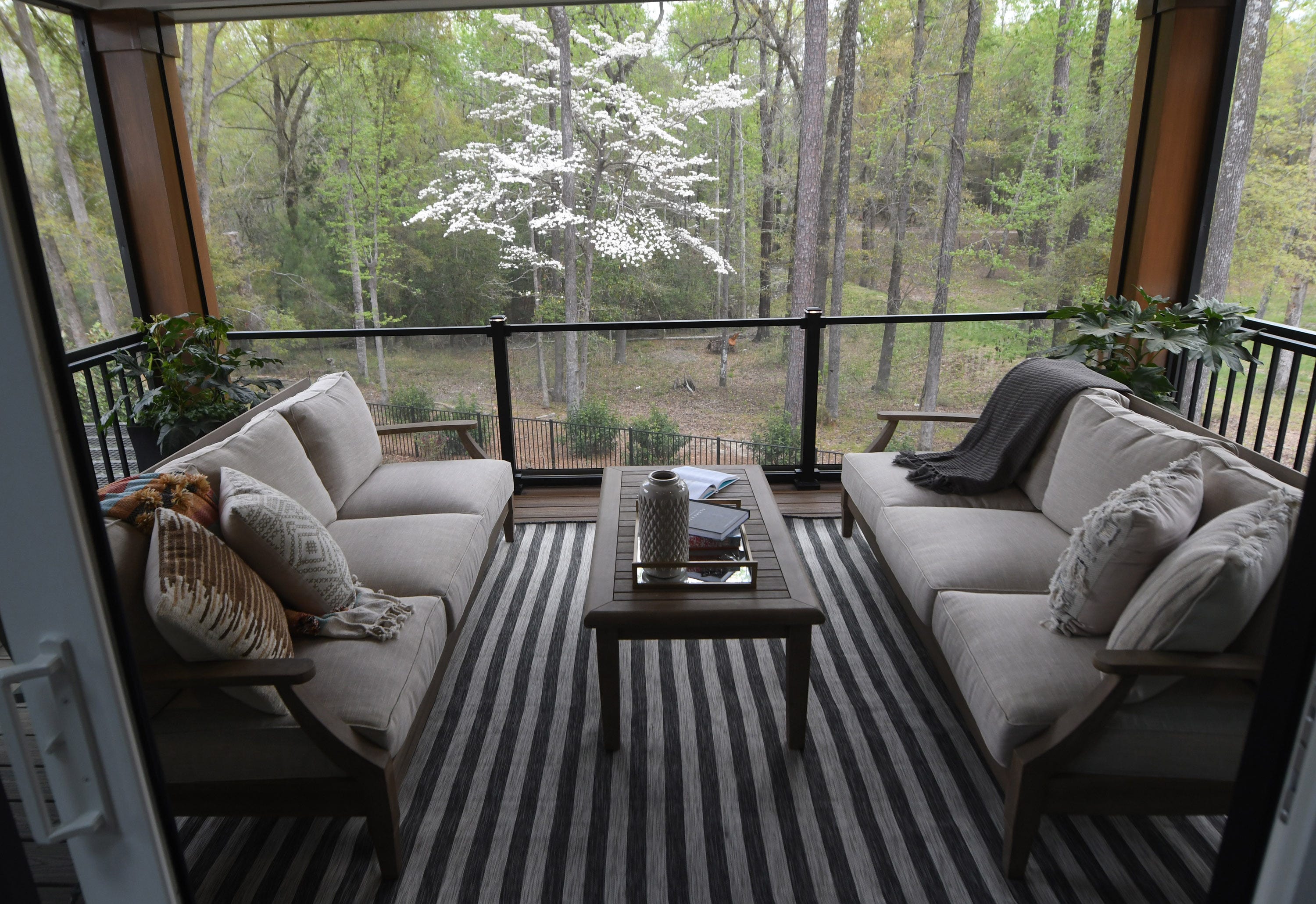 The HGTV Smart Home 2022 has numerous outdoor living features including this second floor screened in porch, in the River Bluffs community in Castle Hayne.  [MATT BORN/STARNEWS]