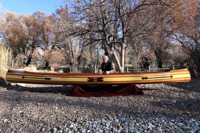 Len Kopec with his hand-made canoe up for auction from April 15-30, 2022.