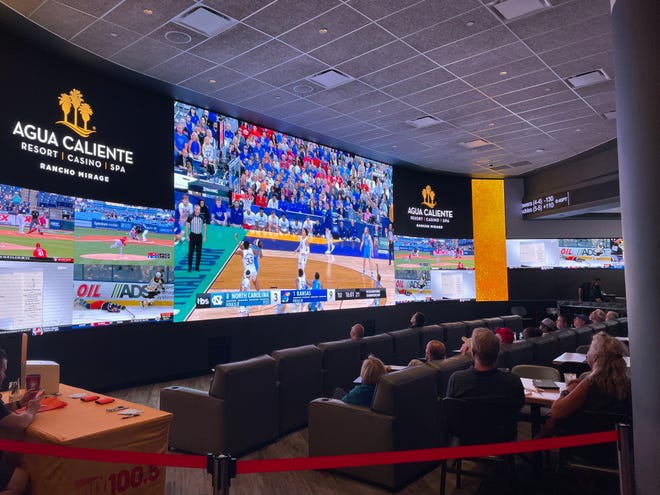 Spectators watch the NCAA men's basketball national championship game at the Agua Caliente Resort Casino and Spa Rancho Mirage on April 4, 2022. California voters could soon make such spots open to sports betting, depending on how they vote on a proposed ballot measure in November.