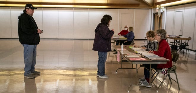 People stand in line to vote at the First United Church poll, Tuesday, April 5, 2022, in Sheboygan, Wis.