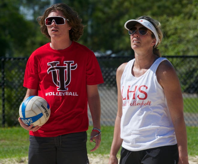 Leon junior student manager/coach Bo Moore and Leon head coach Angie Strickland look on during a beach volleyball practice.