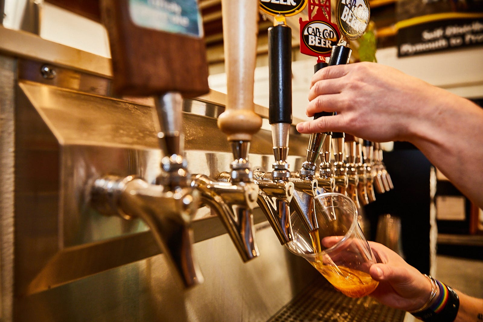 A tap of multiple beers with one being poured