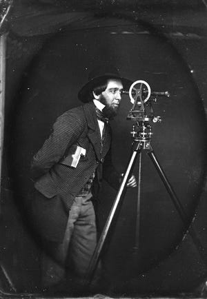 George Y. Wellington, a founder of the Arlington Historical Society, poses in this c. 1860 daguerreotype with surveyor's equipment.