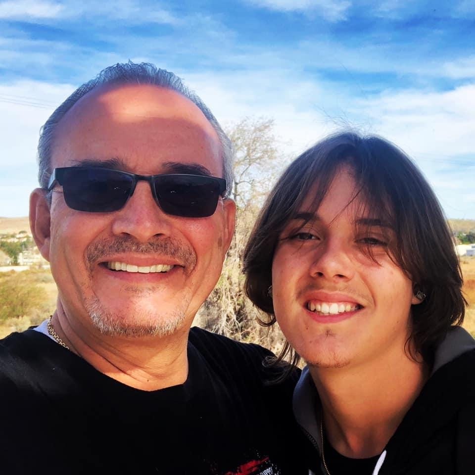 Jaime Puerta and his son, Daniel Puerta-Johnson, smile as Daniel's mom takes a photo in their home state, California. Daniel died in April 2020 at the age of 16 after taking one counterfeit pill, which was disguised as a prescription oxycodone pill. He had been suffering from ADHD and depressive disorder and sought to self-medicate, his father said, buying the pill via a social media app.