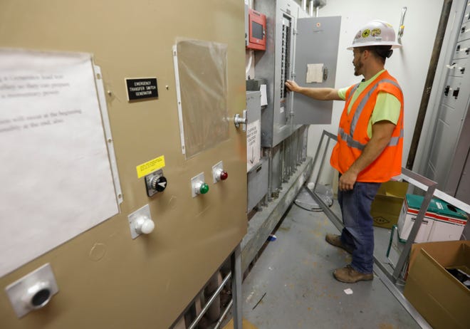 Corey Binney, an electrical apprentice from the Kestrel Apprenticeship Training Center, checks the a breaker box at The Montclair on Wednesday, April 6, 2022.