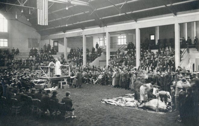 The University of Wisconsin has offered the one- or two-year Short Course to high school graduates since 1885. At one time, Short Course students numbered in the hundreds. Here they gather in the Livestock Pavilion for a livestock demonstration.