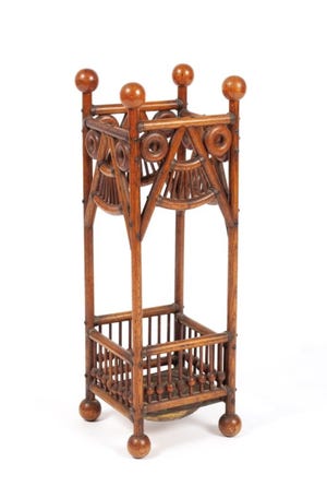 This stick and ball umbrella stand shows that not all Arts and Crafts furniture is plain and dark. It sold for $300 at a recent Selkirk auction.