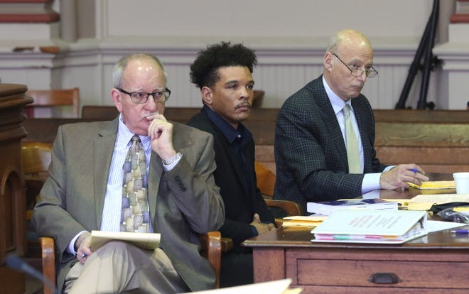 Michael Gillard, center and his attorneys, Harry Reinhart, left, and Neil Rosenberg listen as Assistant Muskingum County Prosecutor Micheal Hughes gives his opening statement in Muskingum County Common Pleas Court on Wednesday. Gillard is accused of raping a 14-year-old girl in 2020.