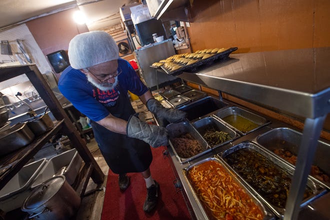 Tyrone Bully,  founder, cook and owner of Bully's soul food restaurant in Jackson, Miss., sets up for the lunch crowd Wednesday, April 6, 2022. Bully gets in at 5 a.m. to cook for an 11 a.m. opening each day.
