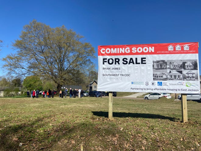 A sign with information about how to apply to purchase one of the new houses in East Jackson faces Whitehall Street while supporters gather at the groundbreaking on Thursday, April 7, 2022.