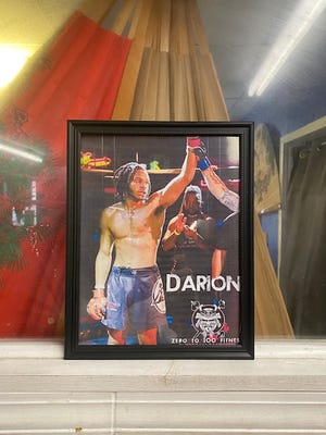 A framed photo of Darion "Leo" Riley, 27, sits in a prominent place at the Zero to 100 Fitness and MMA gym, at 706 N. 26th St. in Milwaukee. Riley trained at the gym for about two years before being killed in a shooting March 23.