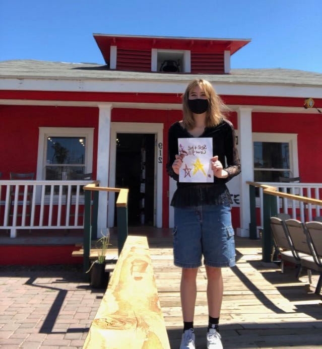 Hannah Whitney in front of Lawn Gnome Publishing.