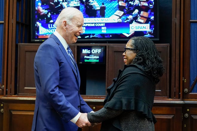 President Joe Biden holds hands with Supreme Court nominee Judge Ketanji Brown Jackson as they watch the Senate vote on her confirmation from the Roosevelt Room of the White House in Washington, Thursday, April 7, 2022.