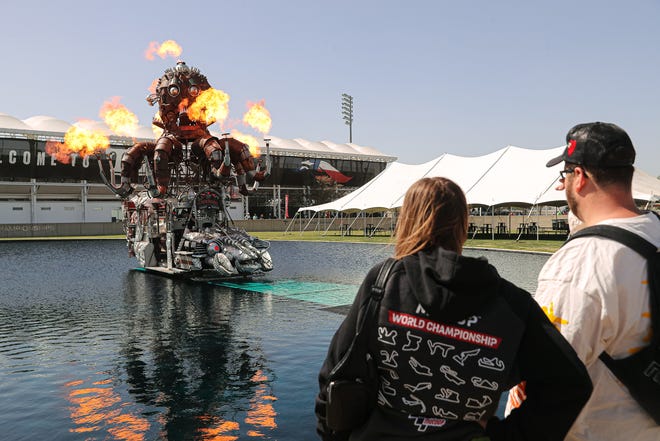 John Seal, right, and his sister Ginger Seal, left, watch "El Pulpo Mecanico," the mechanical octopus, as it shoots flames in sync to music in the Grand Plaza at Circuit of the Americas. COTA hosted its ninth MotoGP Grand Prix of the Americas on Sunday.