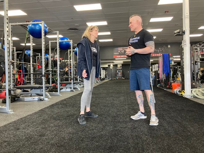Extreme Fitness founder Marty McLoughlin, right, and wife and business partner Linda, chat on the floor of their new 11,000 square foot building on New Falls Road in Falls Township.
