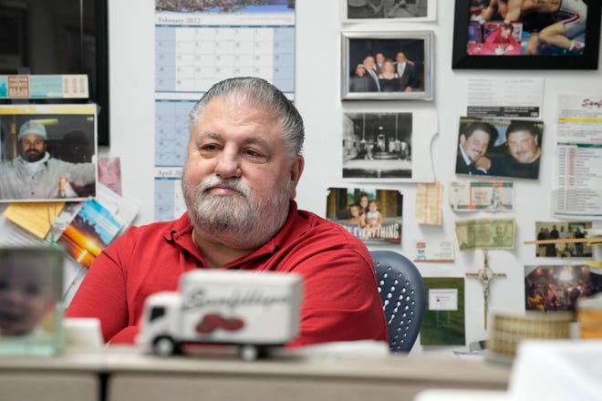Jim Sanfillipo, co-owner of East Side wholesaler Sanfillipo Produce, is surrounded by photos in the office.