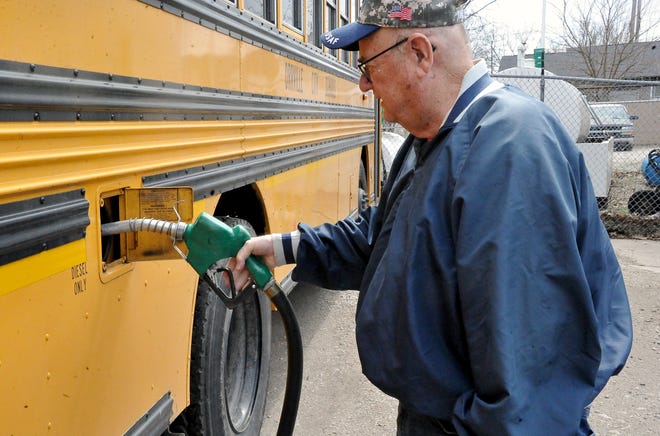 Orrville City Schools bus driver Randy Schoenly fills the tank on a bus April 7. Matthew Wyatt, the district's transportation supervisor, said he requires his drivers to keep the tank more than half full so they don't run out of fuel if they get caught in traffic or other situations.