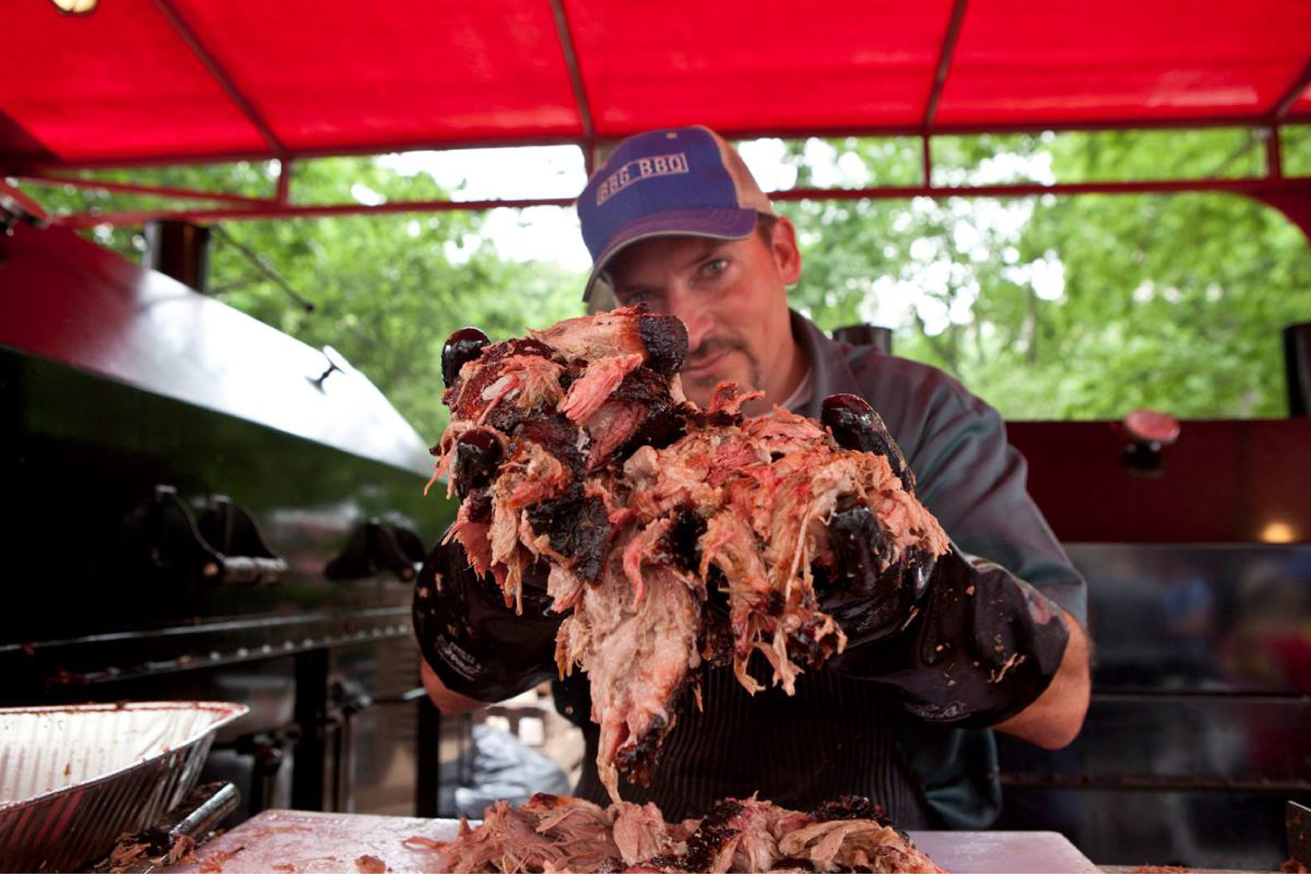 A man holds pulled pork