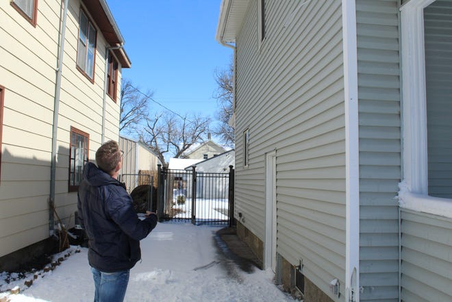 Scott Grebner assess the roof of a house in Aberdeen. Home values have been going up across the state, especially in larger cities.