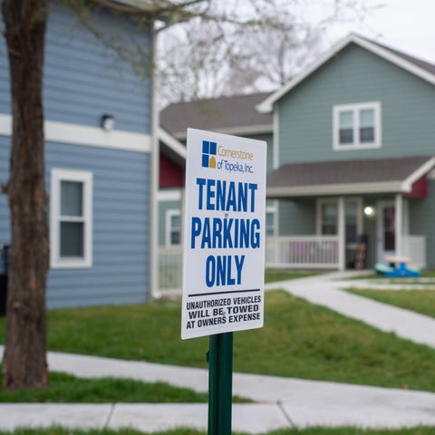 Signs indicate designated parking spots for tenant