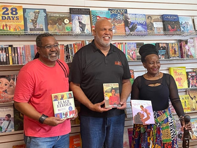 Cocoa Mayor Mike Blake (center) poses with owners and operators of the Essence of Knowledge Bookstore on King Street in Cocoa to kick off the Little Black Book Drive.
