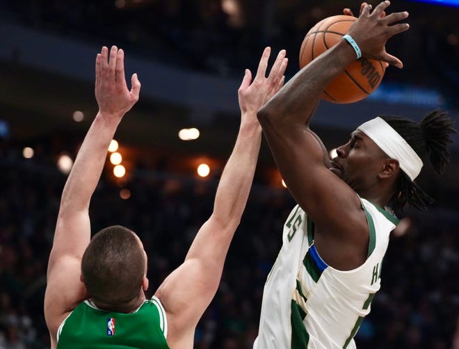 Bucks guard Jrue Holiday drives to the basket as Celtics guard Payton Pritchard guards him during the first half Thursday at Fiserv Forum in Milwaukee.