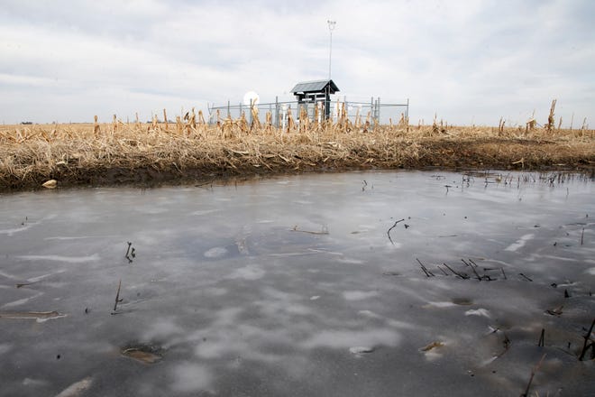 FILE - Frozen water pools in a corn field near a Keystone pipeline pumping station in rural Milford, Neb., Thursday, Jan. 9, 2020. The Supreme Court on Wednesday, April 6, 2022, reinstated for now a Trump-era rule that had curtailed the power of states and Native American tribes to block pipelines and other energy projects that can pollute rivers, streams and other waterways. (AP Photo/Nati Harnik, File)