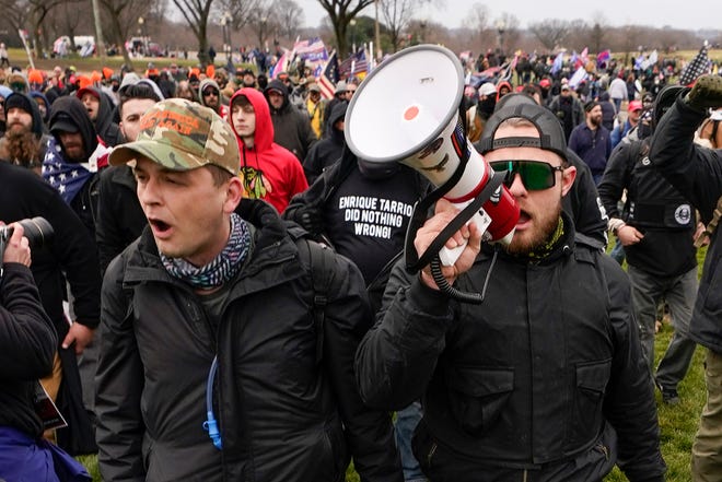 Proud Boys Zachary Rehl, left, and Ethan Nordean march toward the U.S. Capitol on Jan. 6, 2021. Members of the right-wing extremist group were indicted on charges that they planned and carried out a coordinated attack on the Capitol to stop Congress from certifying Joe Biden's victory in the 2020 presidential election.