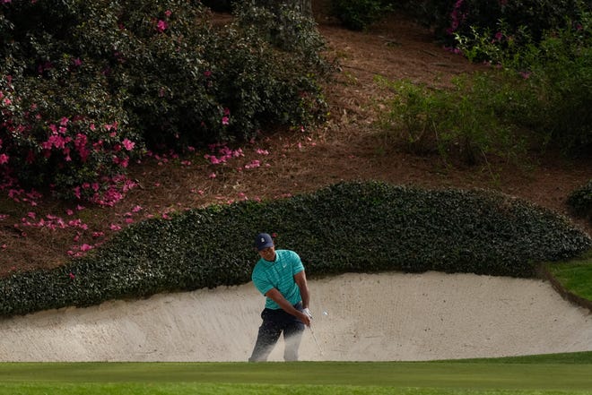 Tiger Woods hits out of a bunker on the 12th hole during the second round at the Masters.