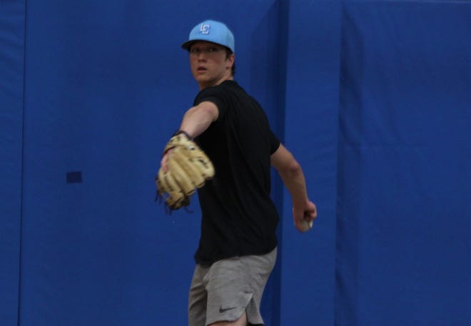 Lutheran senior pitcher Josh Mauney throws during practice indoors on Friday, April 8. He is committed to Frontier Community College.