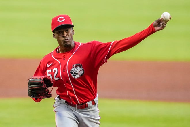 Apr 8, 2022; Cumberland, Georgia, USA; Cincinnati Reds starting pitcher Reiver Sanmartin (52) pitches against the Atlanta Braves during the first inning at Truist Park. Mandatory Credit: Dale Zanine-USA TODAY Sports