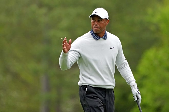 Tiger Woods acknowledges the gallery on the 12th hole during the third round of the Masters.