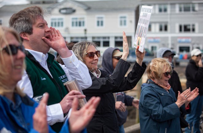 Diane Turco, of Harwich, third from left, cheers for a speaker during the rally against Holtec releasing wastewater from the decommissioned Pilgrim Nuclear Power Station into Cape Cod Bay in Plymouth on Saturday, April 9, 2022.