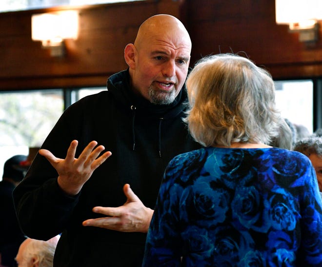 Pennsylvania Lt. Gov. John Fetterman, left, who is running for the Democratic nomination for U.S. Senate, speaks to an attendee at a Centre County Democrats' breakfast event at a hotel at the Mountain View Country Club, Saturday, April 9, 2022, in Boalsburg, Pa. (AP Photo/Marc Levy)