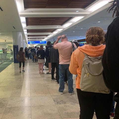 Passengers wait in line to reach the Spirit Airlin