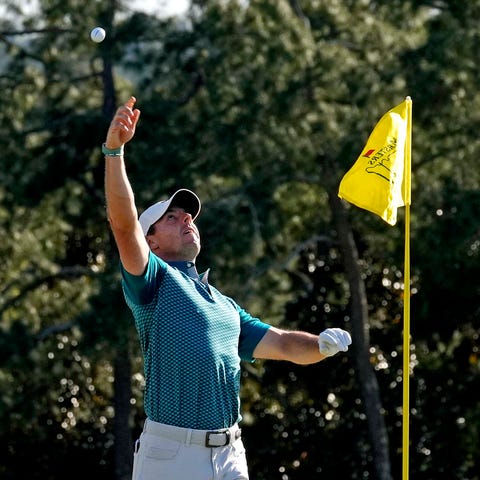 Rory McIlroy celebrates after holing out from a bu