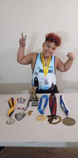 Kameron Stuckey poses with his medals from his successful season in youth wrestling.