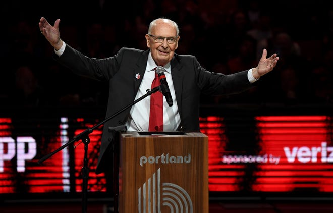 Former radio announcer for the Portland Trail Blazers Bill Schonely reacts to the fans as he is honored during halftime of an NBA basketball game against the Utah Jazz in Portland, Ore., Sunday, April 10, 2022. Schonely was the play-by-play announcer for the Portland Trail Blazers for almost three decades, from the team's launch in 1970 until 1998. He coined the phrase 'Rip City' which has been a Portland Trail Blazer mantra and slogan for decades.