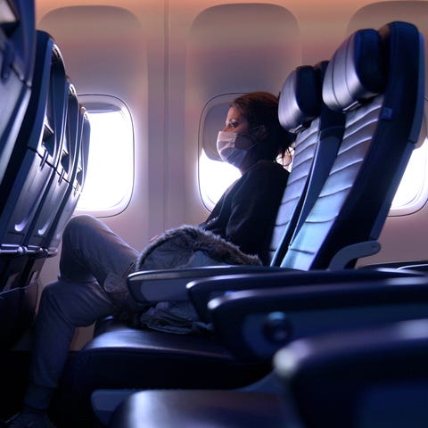 A masked passenger is seen on a flight from San Fr