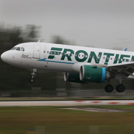 A Frontier Airlines plane lands at Miami International Airport on June 16, 2021.
