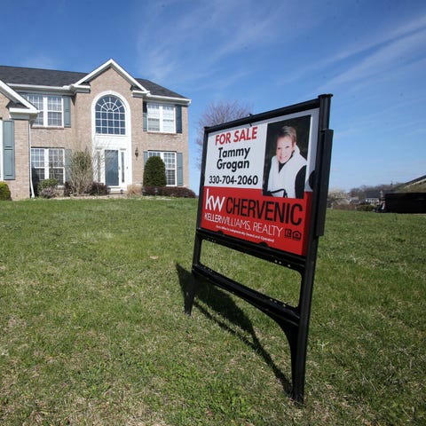 A house is shown with a sign that reads "for sale"