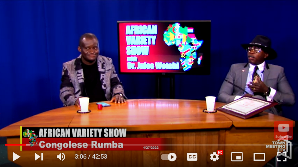 Jules Wetchi and musician Alban Audrey Malanda sit and talk on an episode of the African Variety Show. Wetchi is a public health expert and host of the show on both television and radio, both of which he uses to celebrate African culture and share information.