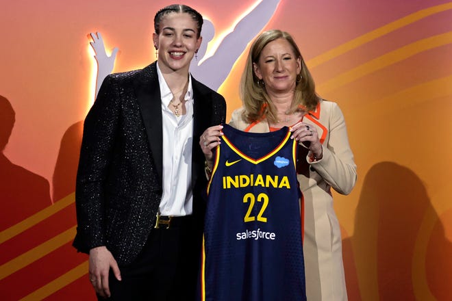 Louisville's Emily Engstler, left, poses for a photo with Commissioner Cathy Engelbert after being selected by the Indiana Fever as the fourth overall pick in the WNBA basketball draft, Monday, April 11, 2022, in New York. (AP Photo/Adam Hunger)