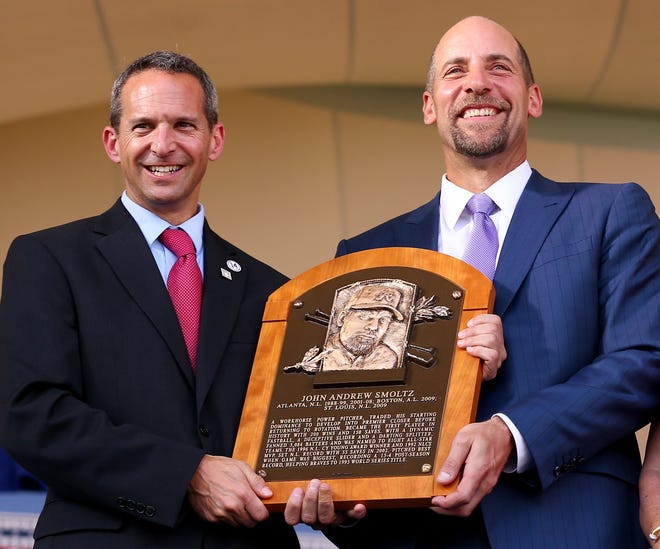 Hall of Fame President Jeff Idelson presents to John Smoltz his Hall of Fame Plaque during the Induction Ceremony at the National Baseball Hall of Fame on July 26, 2015, in Cooperstown, New York.